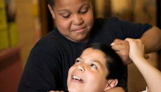 An overweight child bullies another student. An overweight child bullies another student.